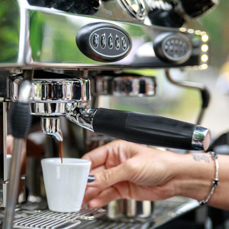 Barista making coffee using professional espresso machine